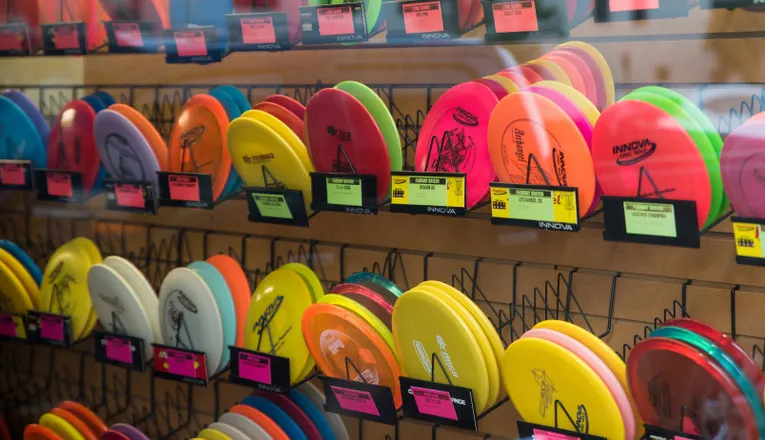 Disc golf drivers on a shelf