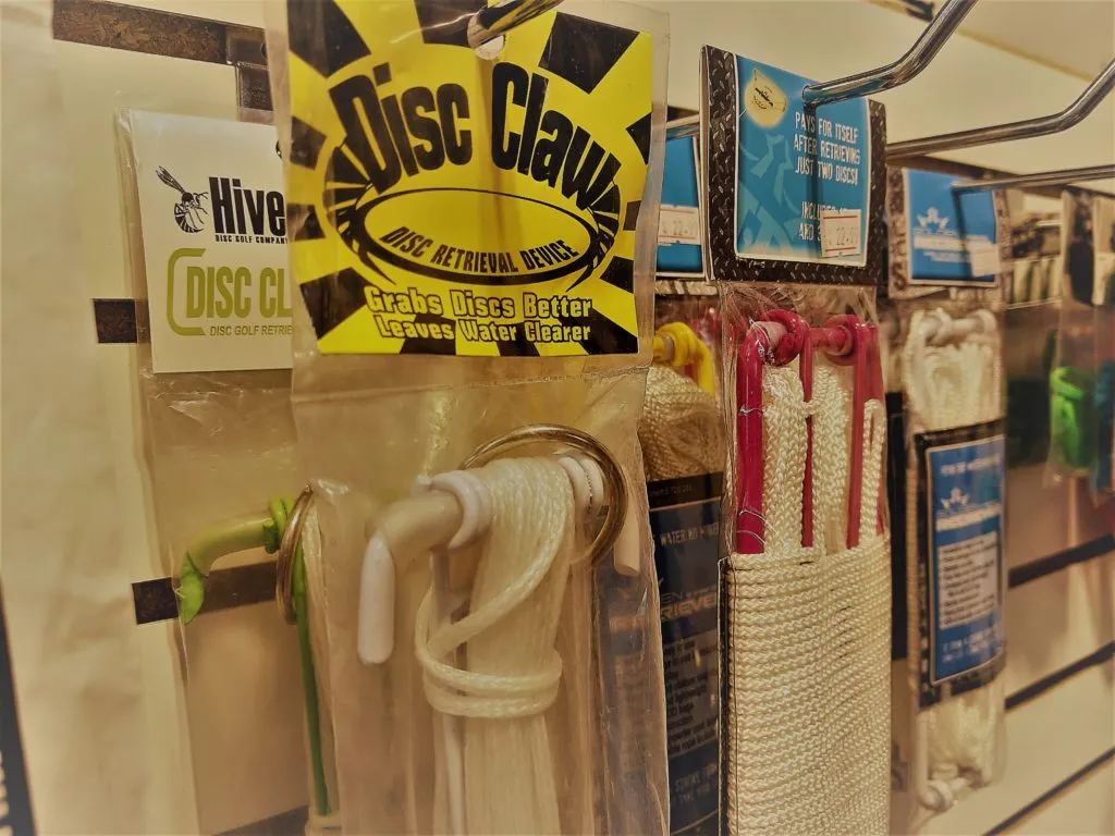 Disc Golf Retrievers Hanging on Slat Wall