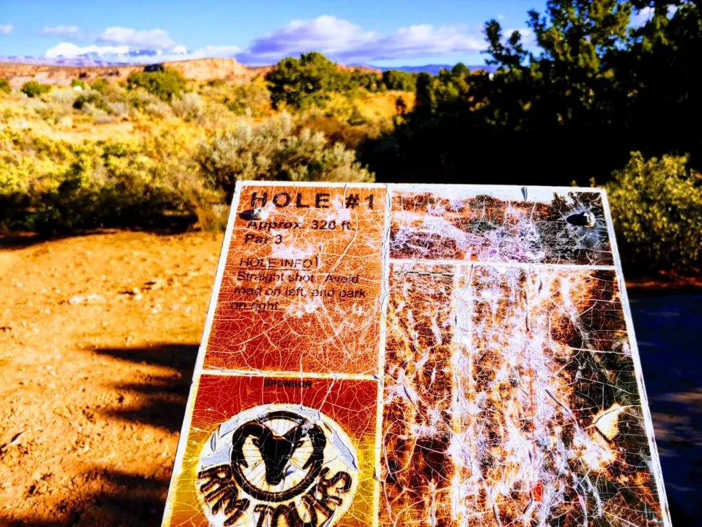 Poor Disc Golf Sign faded in sun